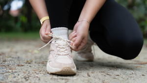 woman's hands lacing shoe